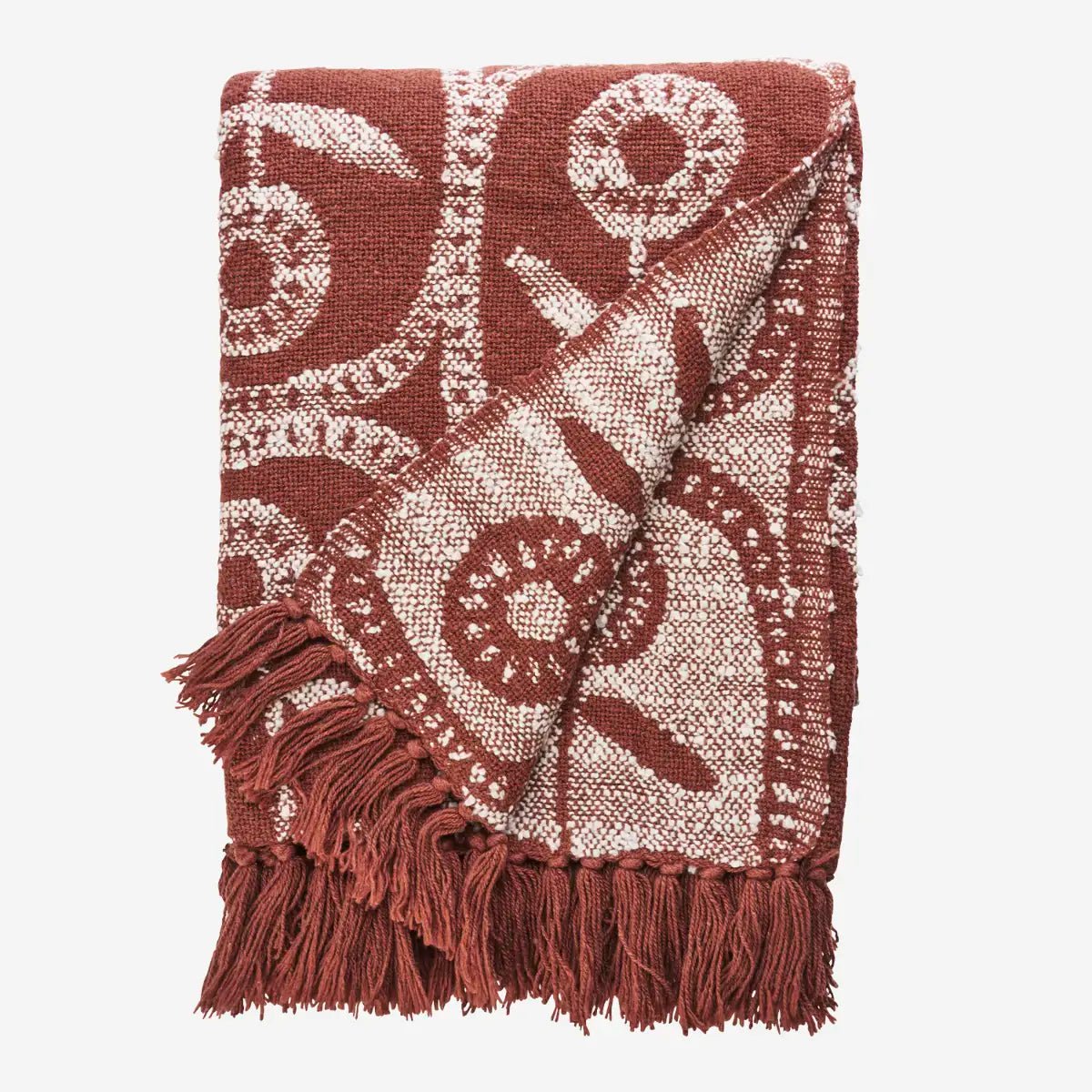 Het opvallende bloemenpatroon in roestbruin en off-white is geïnspireerd op de krachtige grafische ontwerpen uit de jaren 50