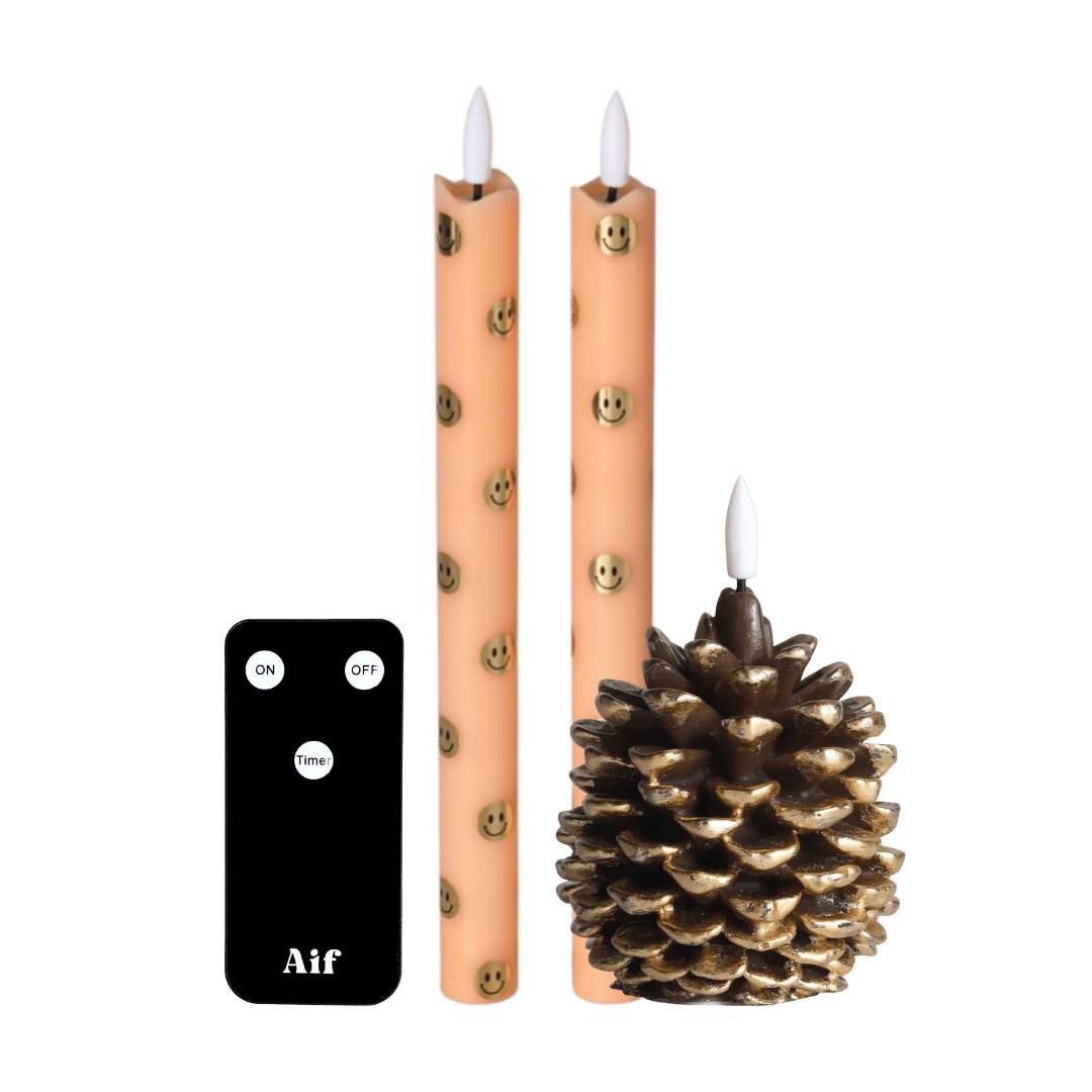  Deze sfeervolle set bestaat uit twee dinerkaarsen met vrolijke smiley-details en een decoratieve led dennenappelkaars met subtiele gouden accenten. 