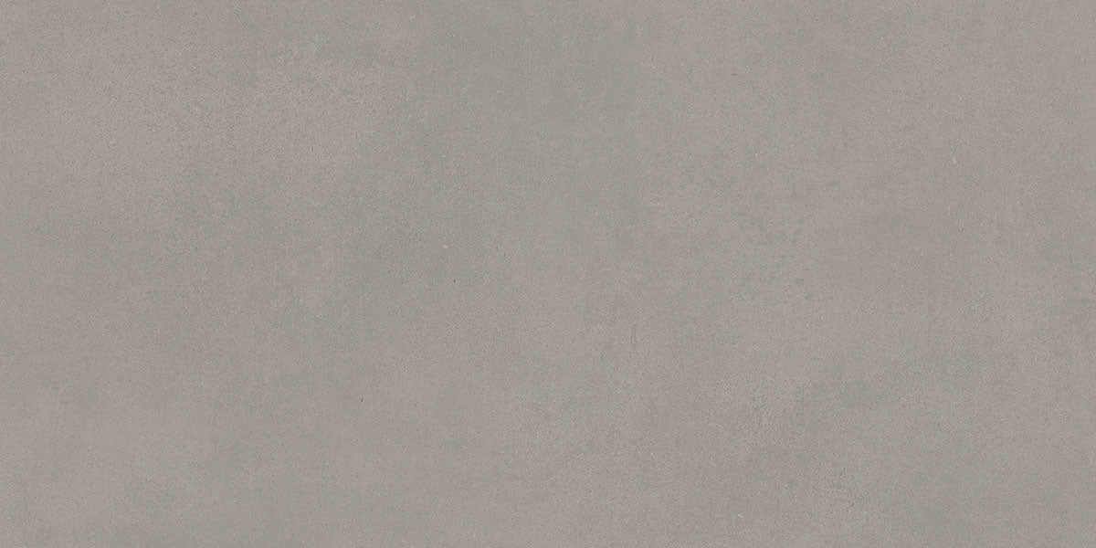 Taupe betonlook vloertegel met zachte overgangen tussen licht en donker.
